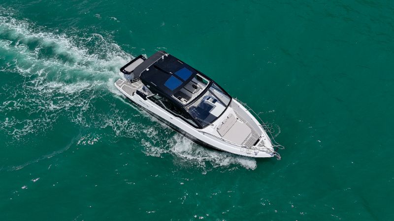 Man consulting with a financial advisor about boat financing options in a modern office with boat models displayed 