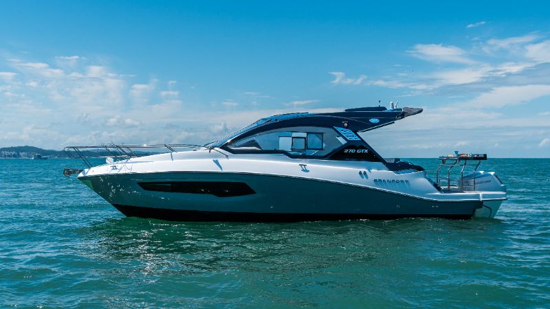 Premium luxury boats anchored in a clear North Carolina coastal bay with lush greenery and calm blue waters 