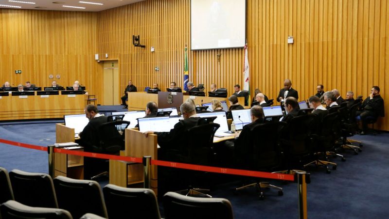 Pleno do Tribunal Superior do Trabalho em sessão virtual com juízes analisando teses vinculantes em telões 
