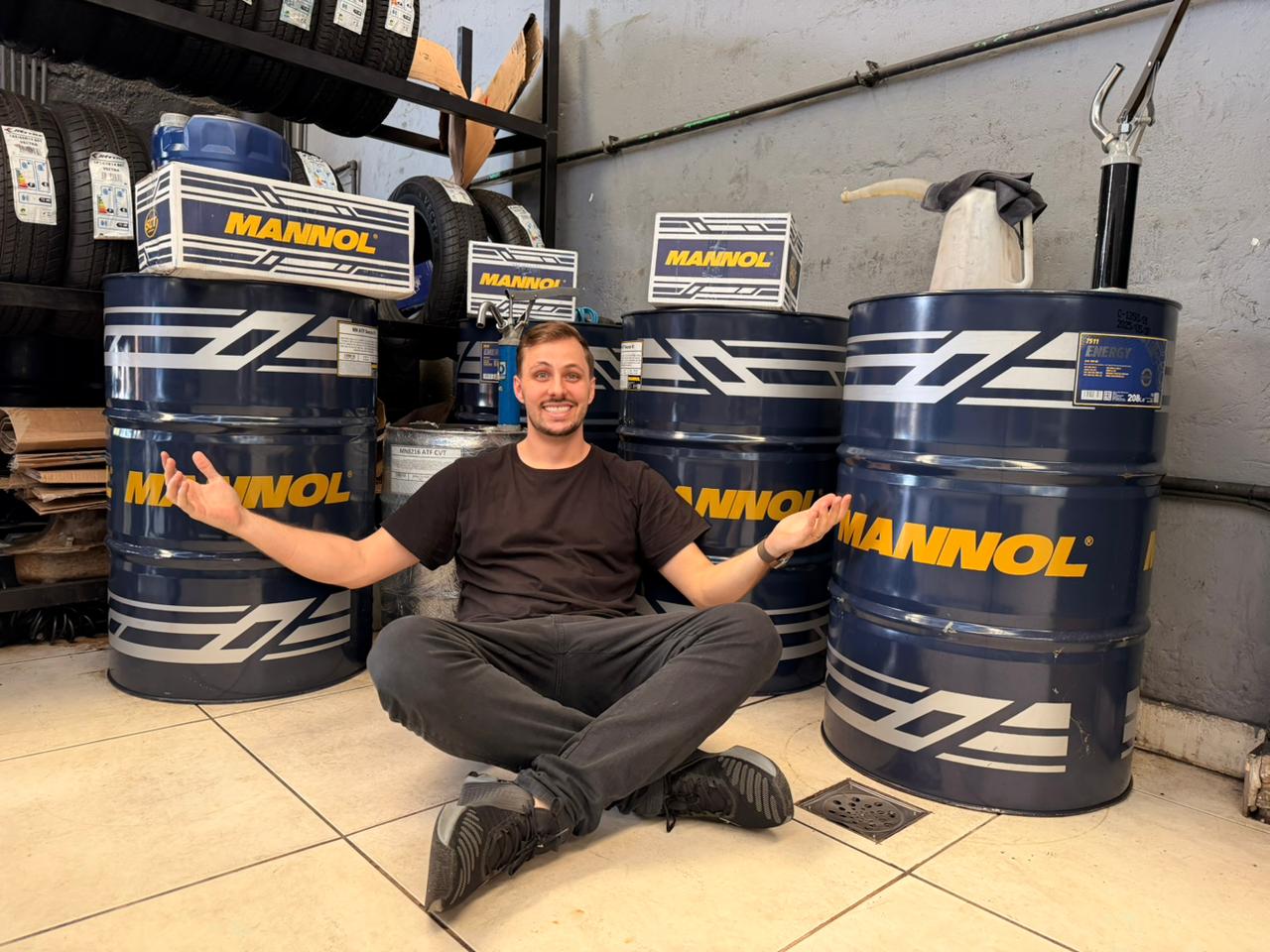 Frasco de lubrificante Mannol ao lado de motor moderno em destaque na oficina 