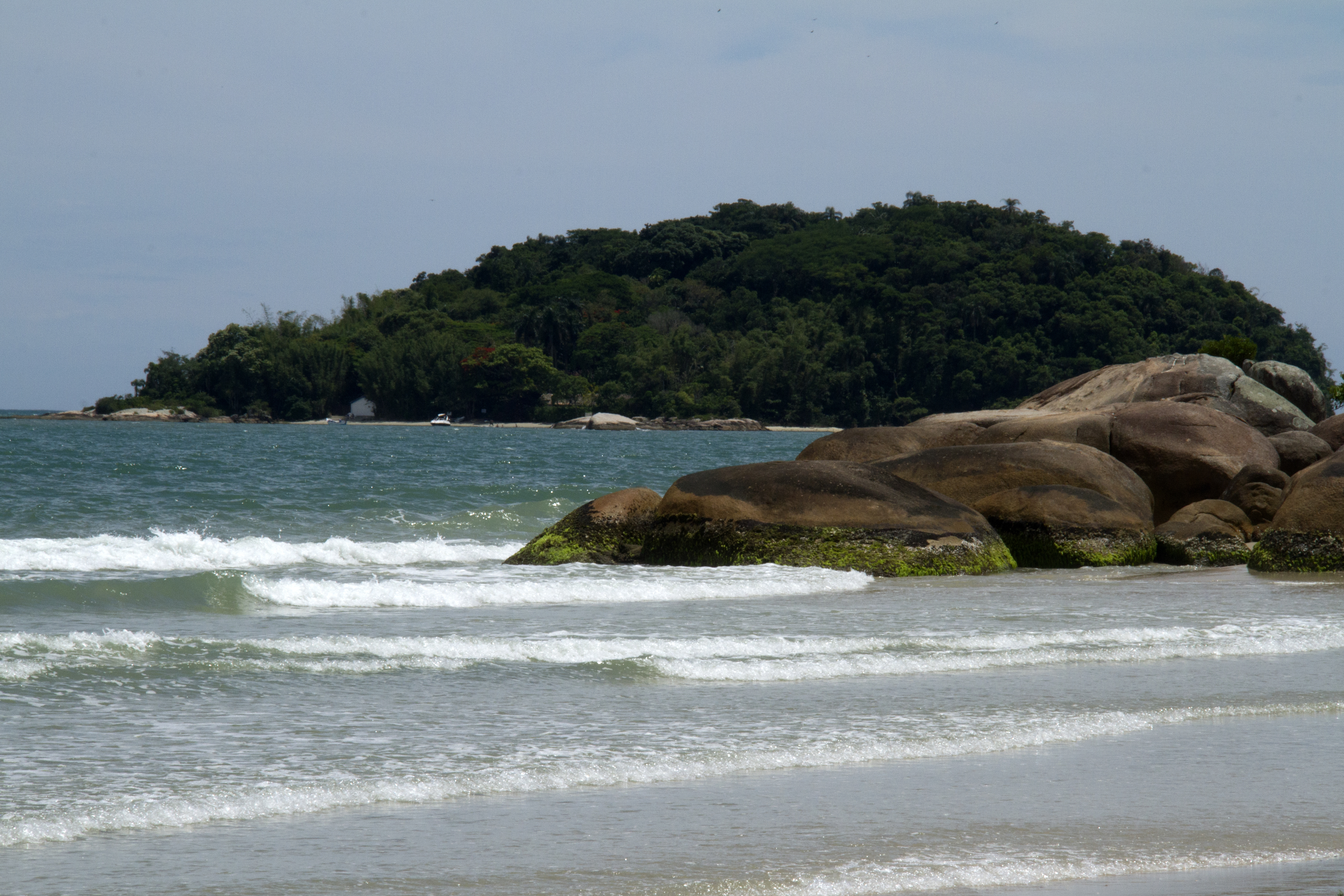 Atletas do Ironman pedalam em avenida arborizada perto de condomínio em Jurerê 
